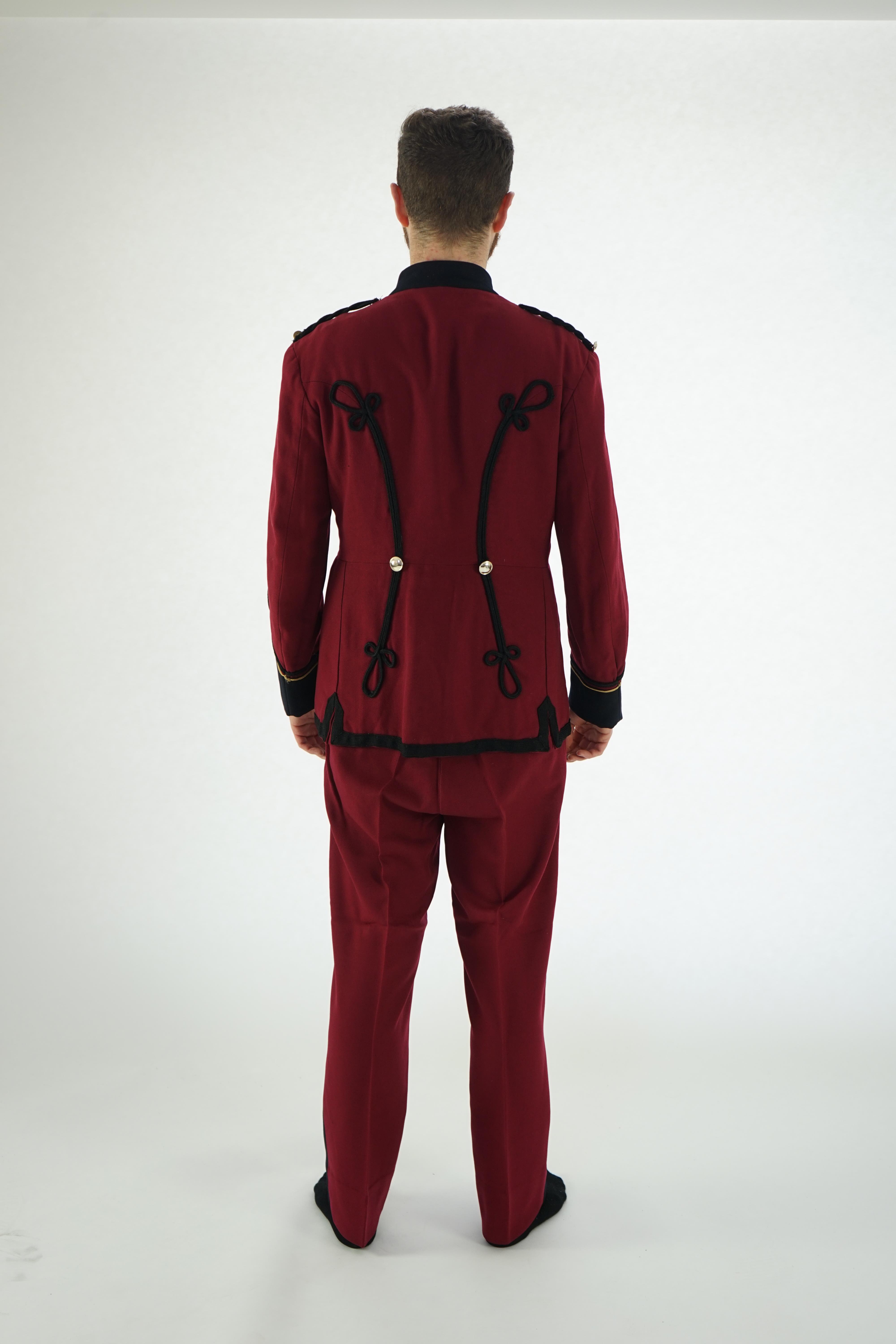 An early 20th century burgundy and black trim Military/Bandsman's uniform jacket and trousers.